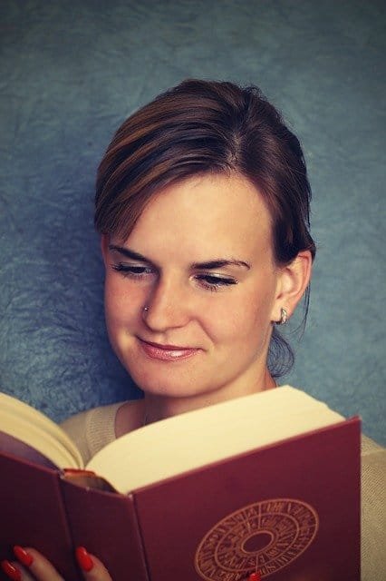 Close-up of a female student studying a book.