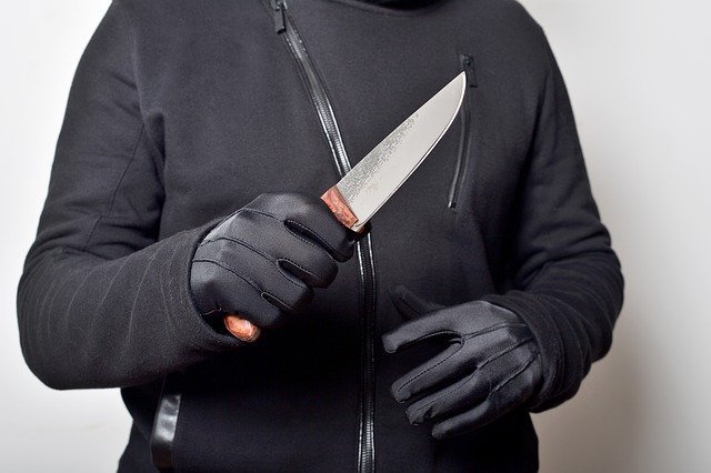 Man holds knife. He's a productivity killer.