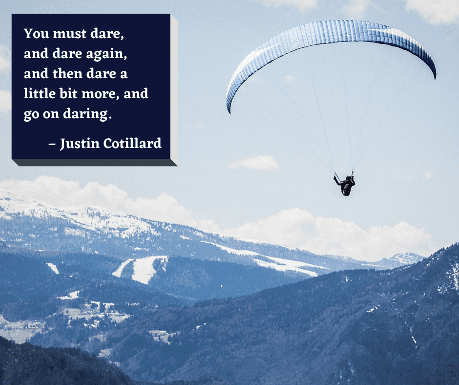 The 18th motivational quote is overlaid on the photo of a hand glider flying over a mountain range.