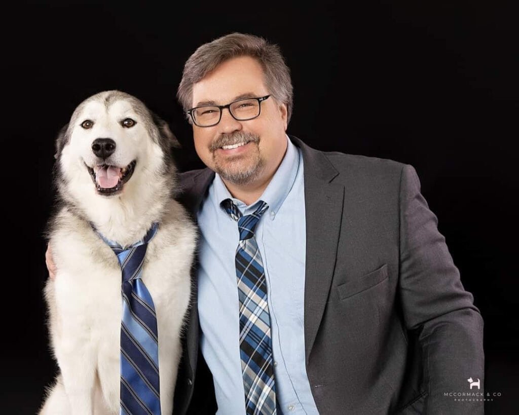 Picture of document reviewer, Mr. John McHugh, sitting next to his dog.