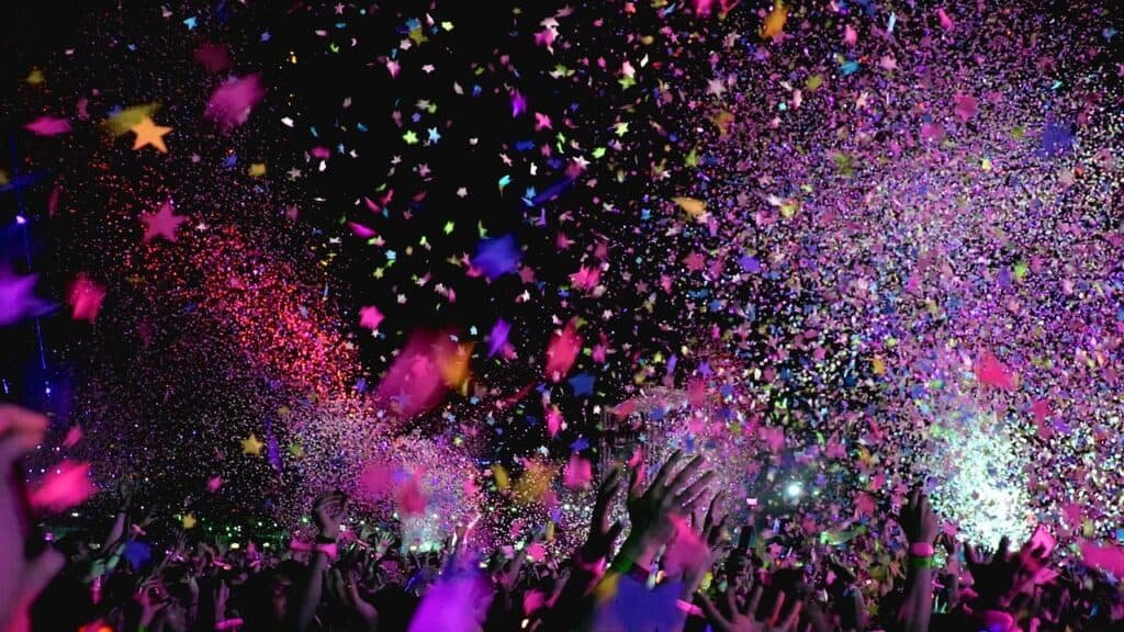 Image of people throwing multicolored confetti in the air, blanketing a stadium, celebrating a decade of coaching graduate students (okay, that's probably not what they were celebrating but that's how I feel).