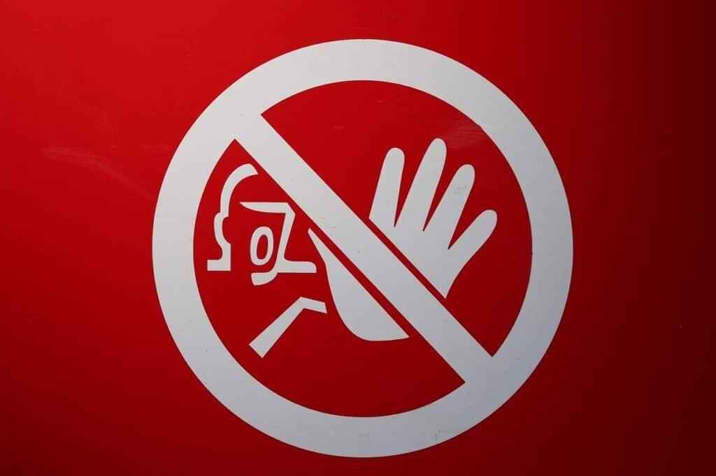 3 Lessons Graduate Students Learned the Hard Way Featured Image shows a red sign with a person - hand held out in warning.